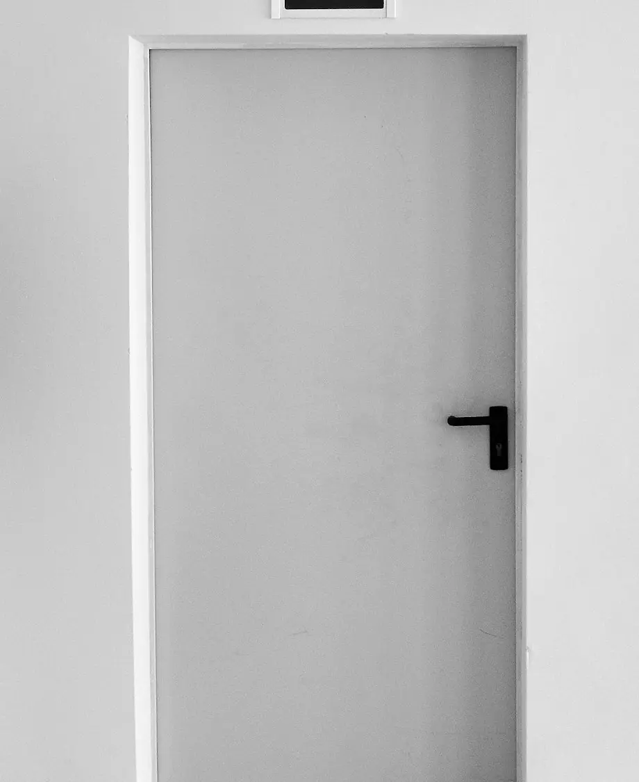 closed white painted door with exit signage
